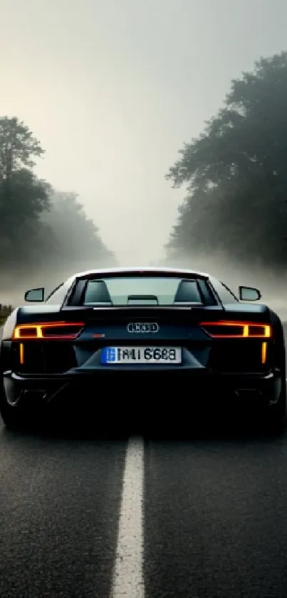 Sleek sports car on a foggy forest road.