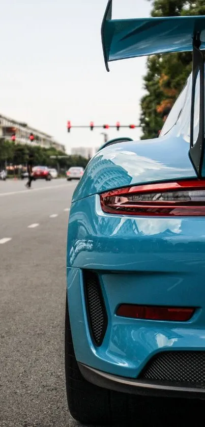 Blue sports car on urban street showcasing sleek design.