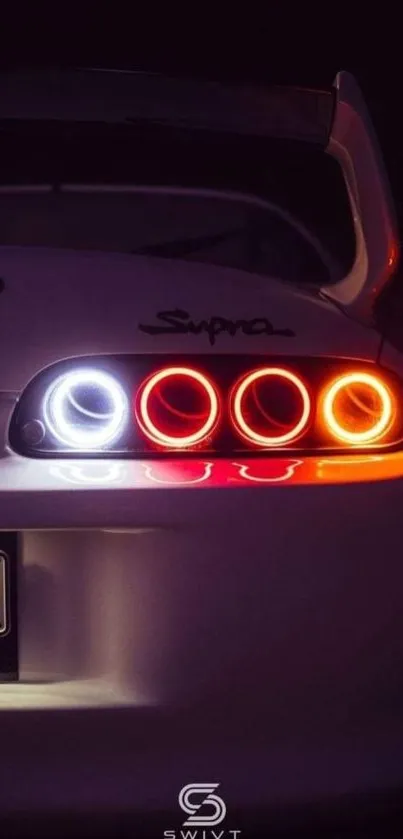 Mobile wallpaper of sleek sports car's tail lights at night.