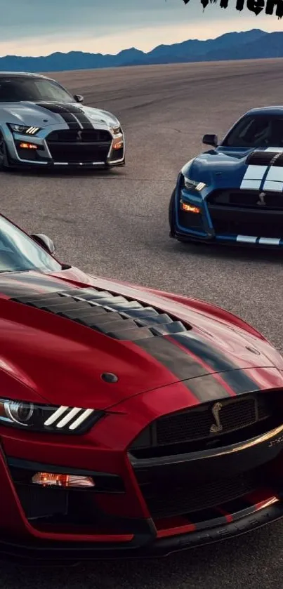 Vibrant red sports car leads an exhilarating road scene with two companions.