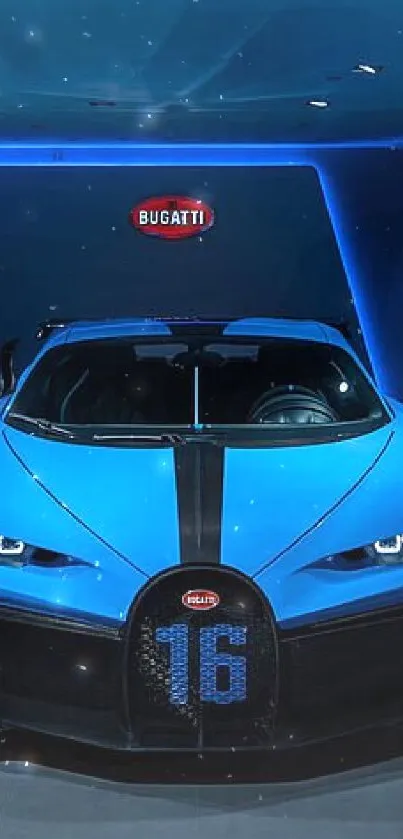 Front view of a sleek blue sports car in a dimly lit showroom.