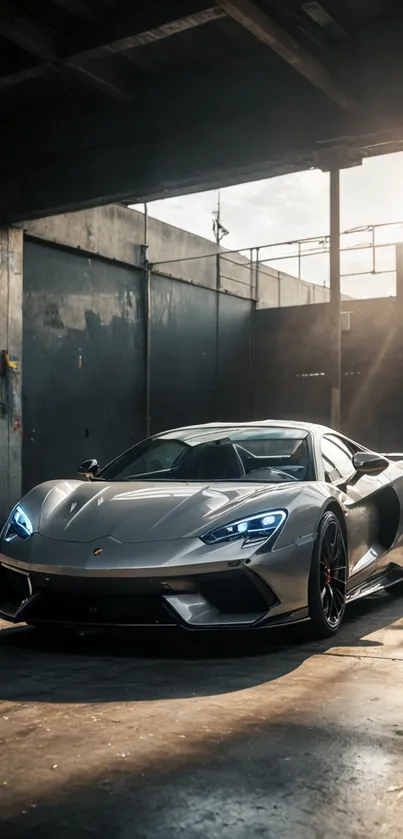 Sleek silver sports car in industrial setting.