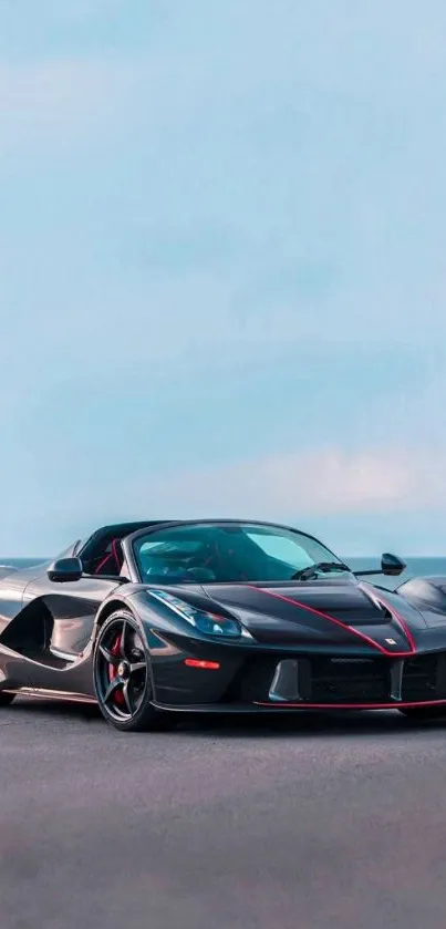 Sleek black sports car with ocean view in background.