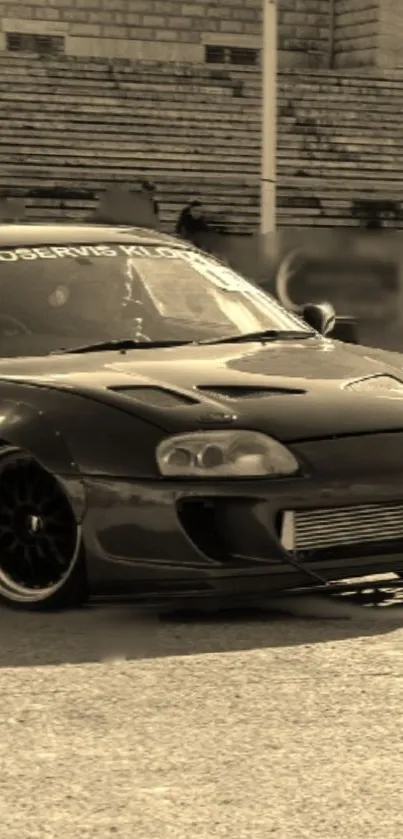 Sepia-toned sleek sports car parked outdoors.