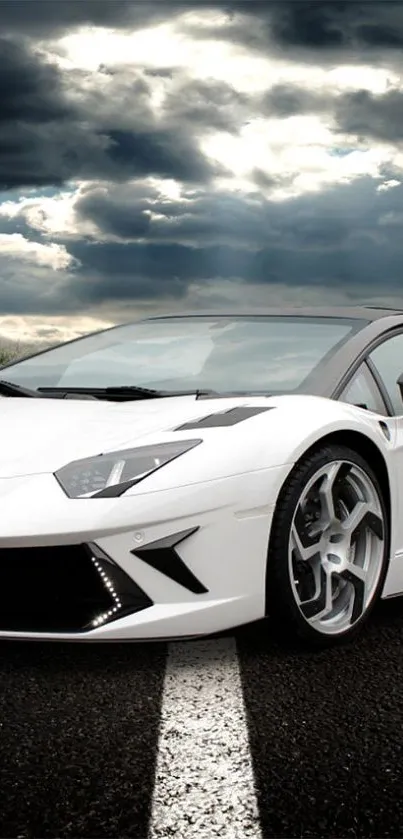 Dynamic sports car on open road under dramatic sky.