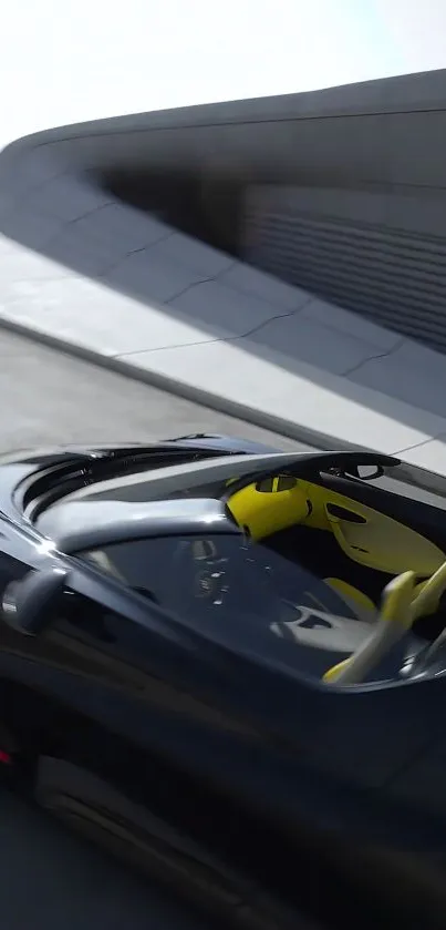 Sleek black sports car with yellow interior on a modern road.