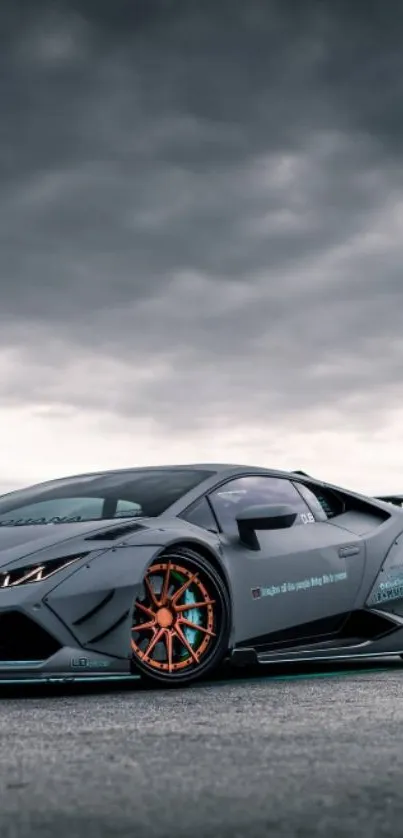 Sleek sports car under a cloudy sky.