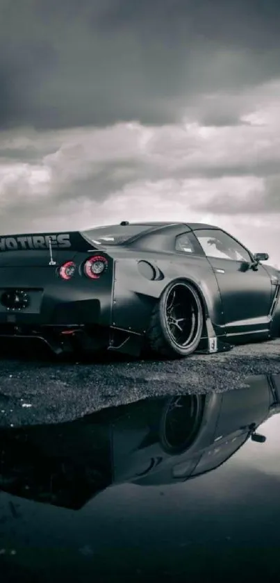 Sleek sports car reflected on wet pavement with dramatic clouds.