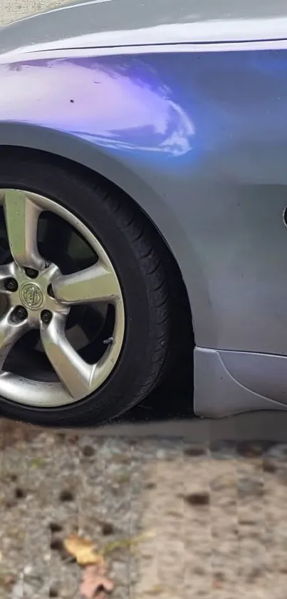 Close-up view of a sleek sports car wheel with metallic detail and dynamic style.