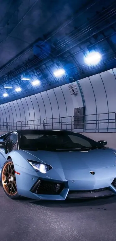 Sleek blue sportscar in modestly lit urban tunnel.