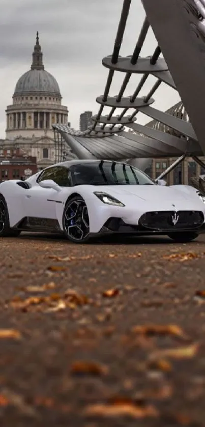 White supercar on city street with iconic urban backdrop.