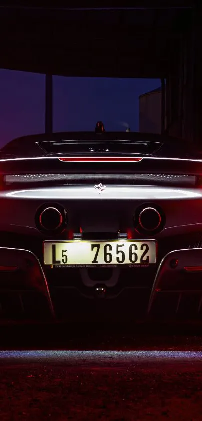 Sleek supercar rear view at night with glowing red taillights.