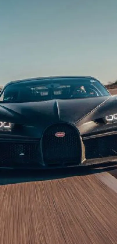 Supercar speeding on a racetrack under a clear sky.