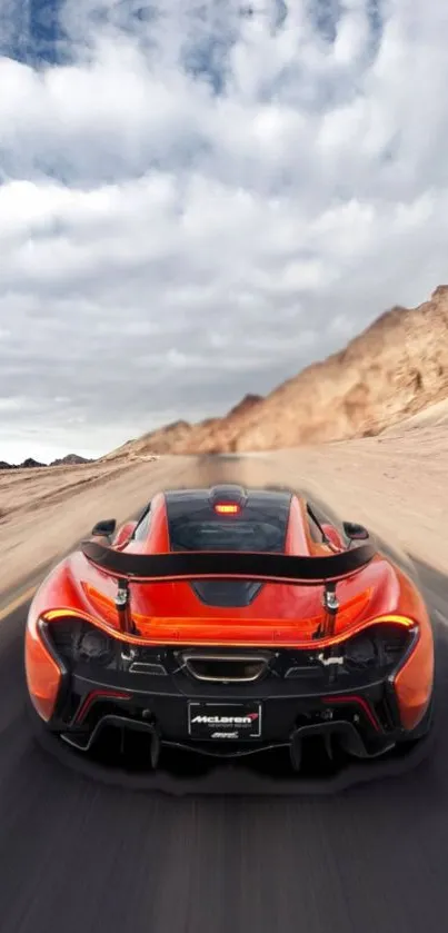 Supercar on an open highway with mountains in the background.