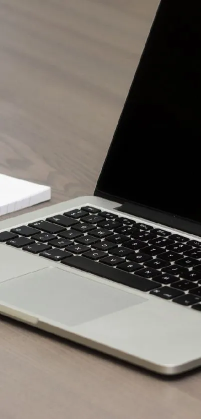 Modern tech desk setup with laptop and smartphone.