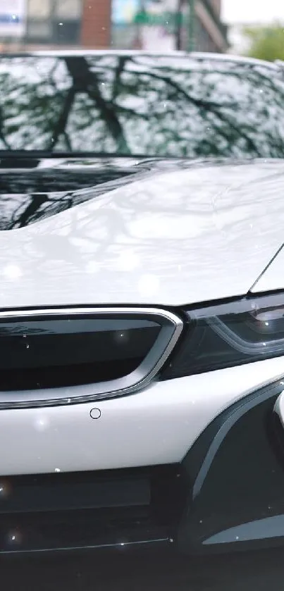 Sleek white car on a bustling city street.