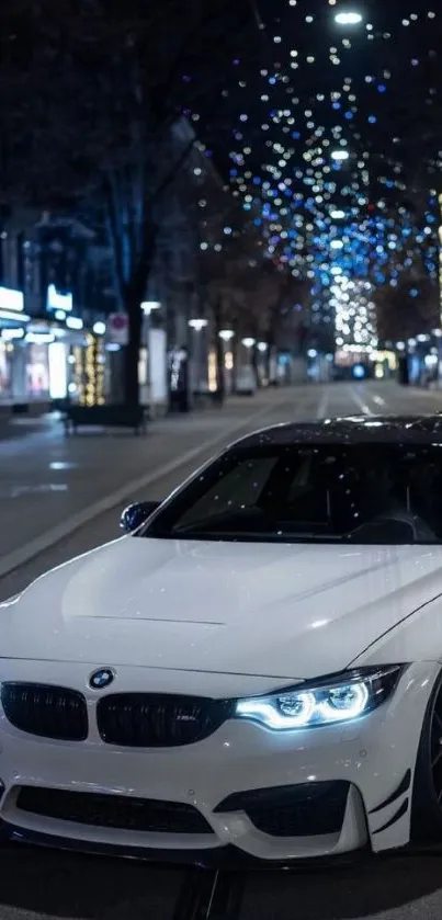 White car parked on a night city street with colorful lights.