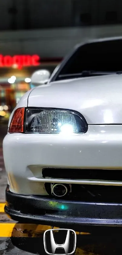 Sleek white car parked in a vibrant urban night scene.