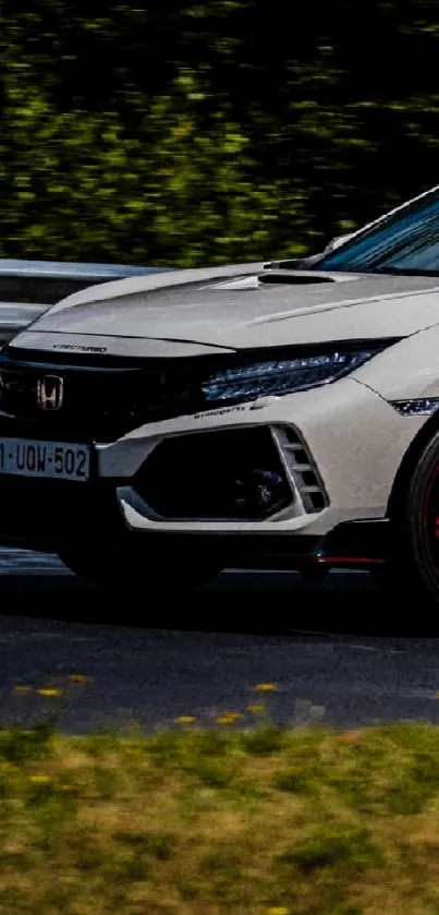 Sleek white sports car on a race track.