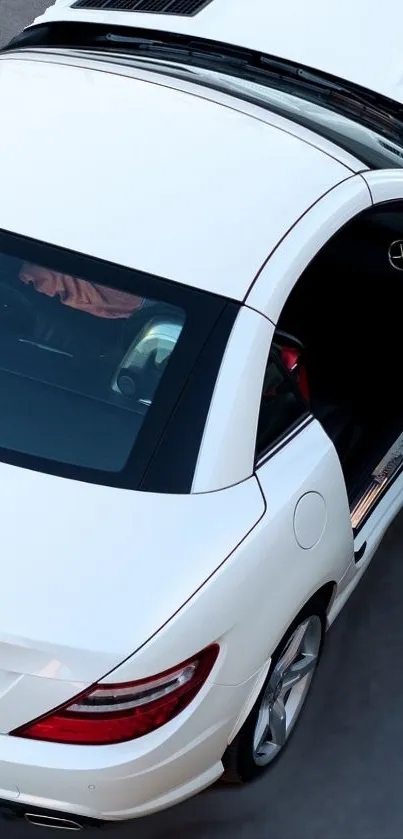 White convertible car with open roof showcasing interior elegance.