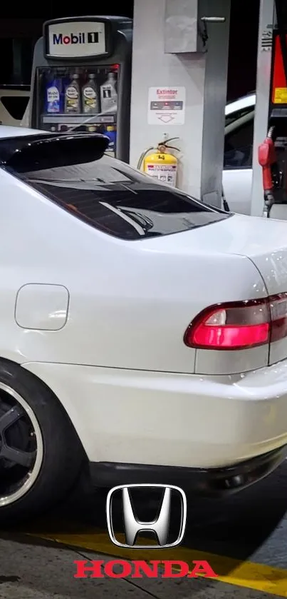 Sleek white Honda parked at a gas station with visible logo.