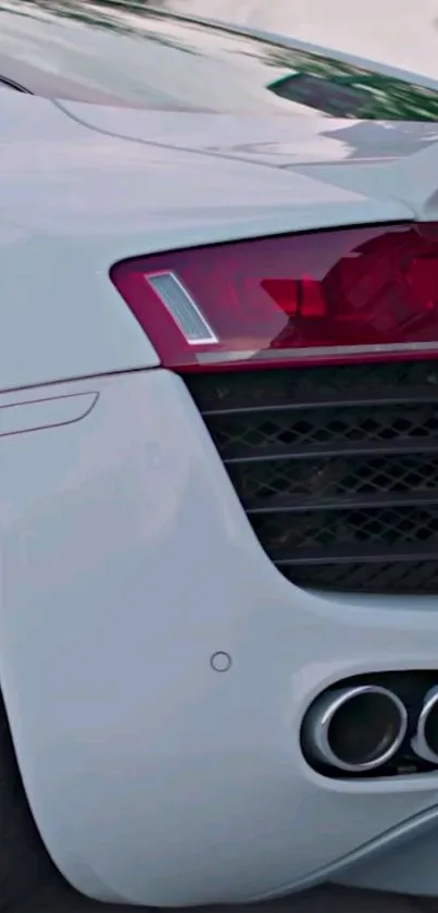 White sports car with red accents and dual exhaust pipes.