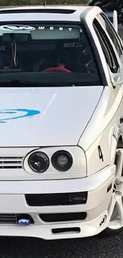 Front view of a sleek white sports car with stylish design.