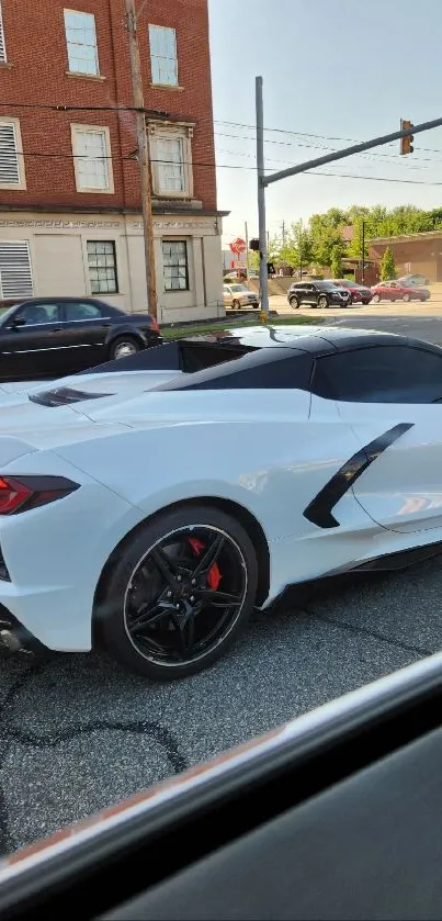 White sports car in urban setting on a sunny day.