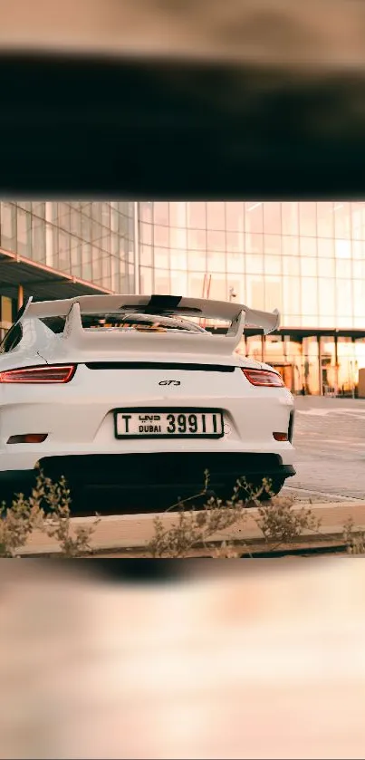 Sleek white sports car in urban backdrop.