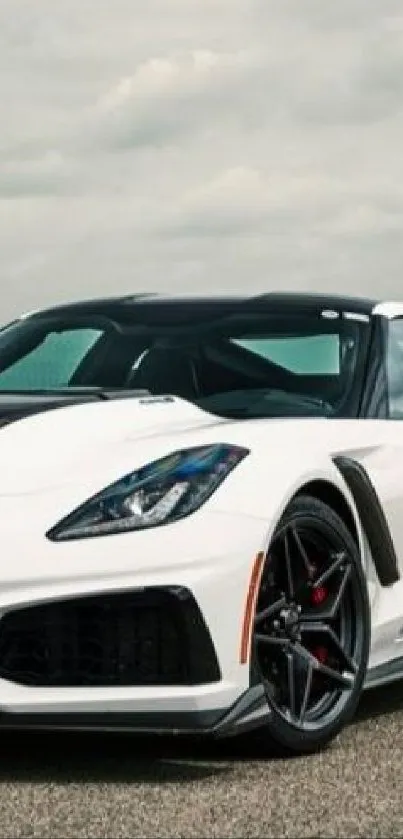 Sleek white sports car with stylish design on a scenic road.