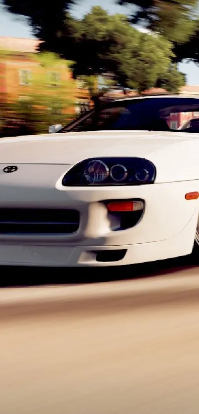 Sleek white sports car driving fast on scenic road.