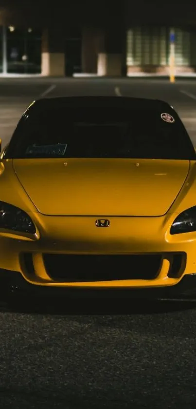 Sleek yellow car in a dimly lit setting, perfect for wallpaper.