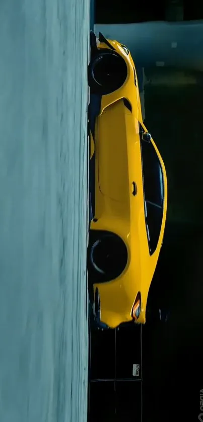 High-performance yellow sports car against dark urban backdrop.