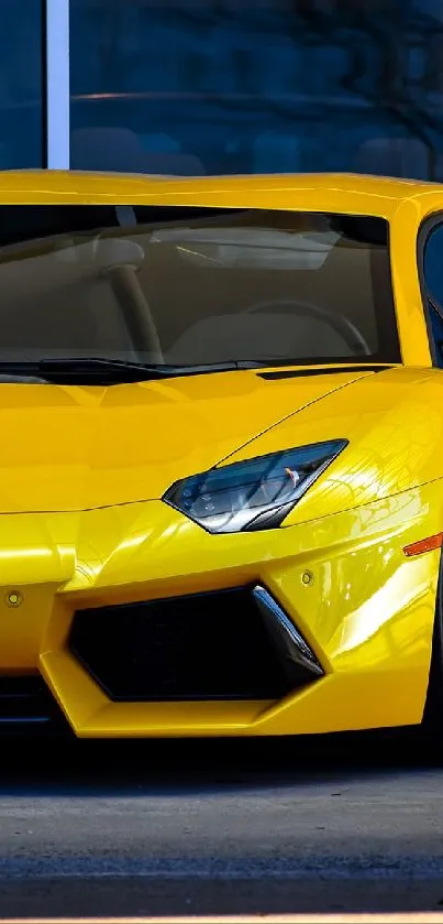 Yellow Lamborghini sports car parked outside a building.