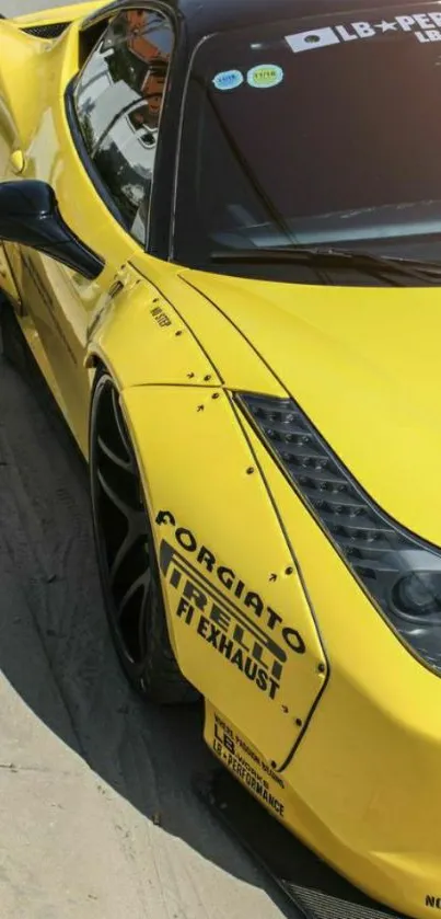 Yellow sports car parked on pavement, showcasing sleek design.