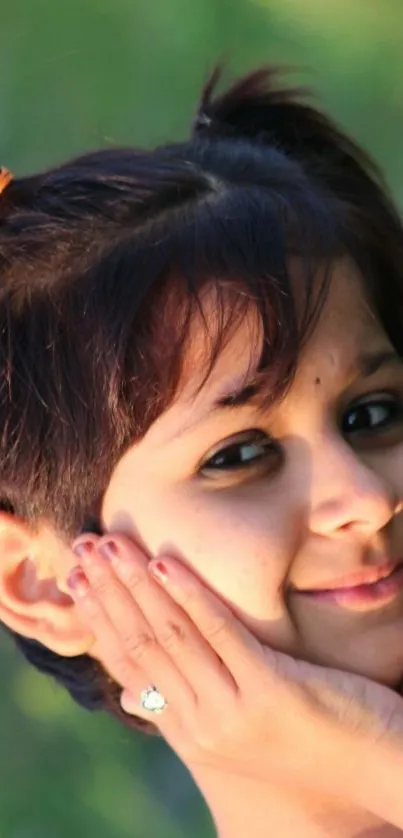 Smiling child portrait against green nature background.