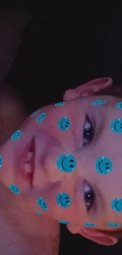 Smiling face overlay on mobile wallpaper with blue dots.