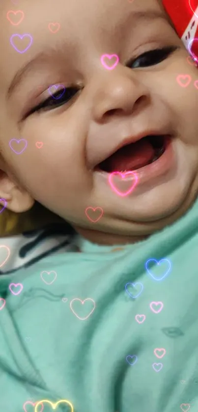 Smiling baby with heart overlays wallpaper.