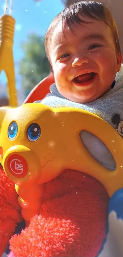 Smiling baby in a colorful swing outdoors.