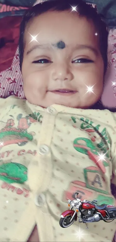 Smiling baby with stars wallpaper in a yellow outfit.