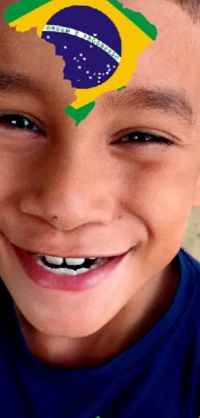 Smiling boy with Brazilian flag art on forehead.