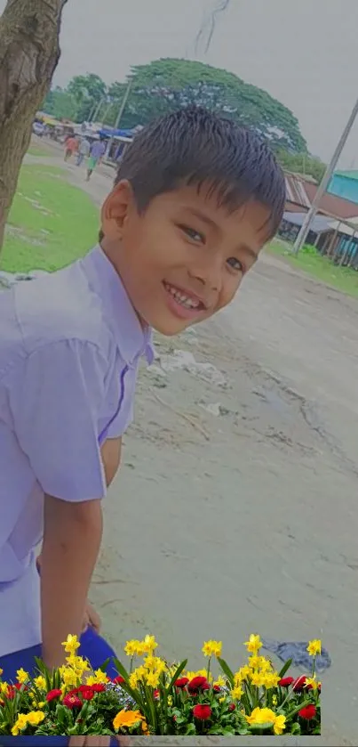 Smiling boy in nature with vibrant flowers.