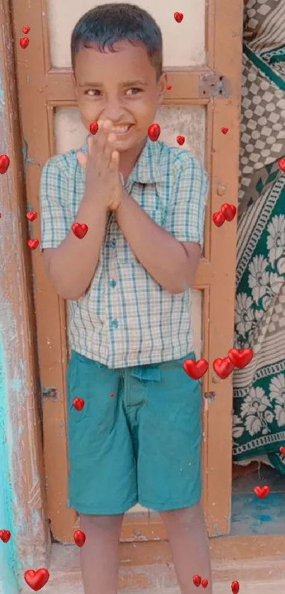 Smiling child standing at colorful doorway.