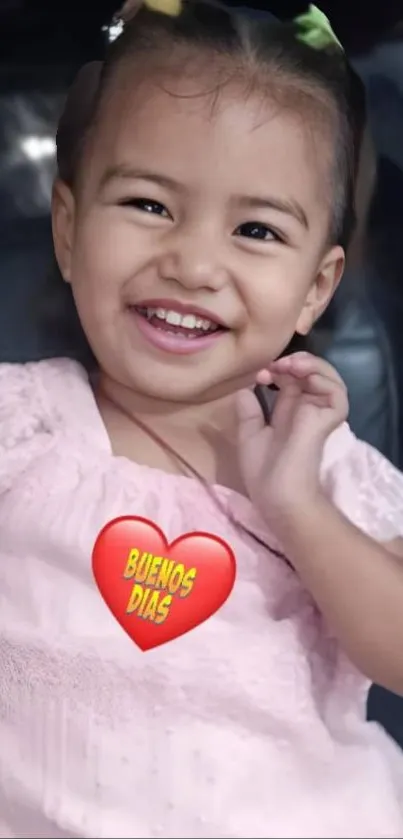 Child smiling with a 'Buenos Dias' heart graphic.