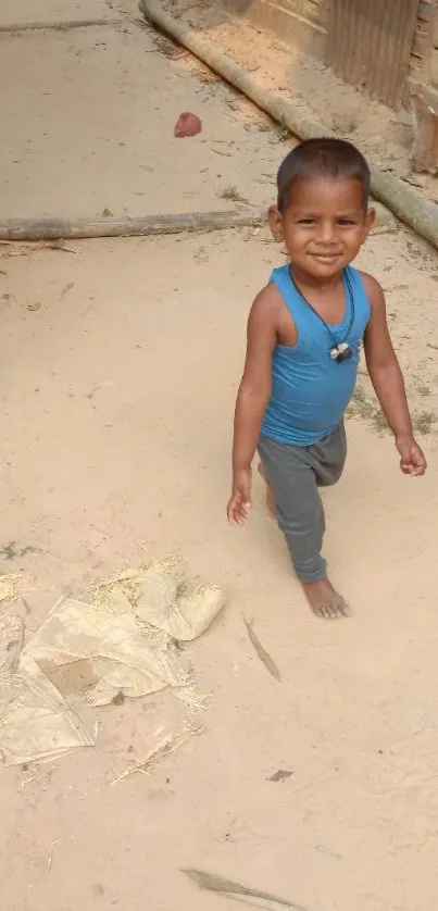 Smiling child walking on a sandy path in nature.