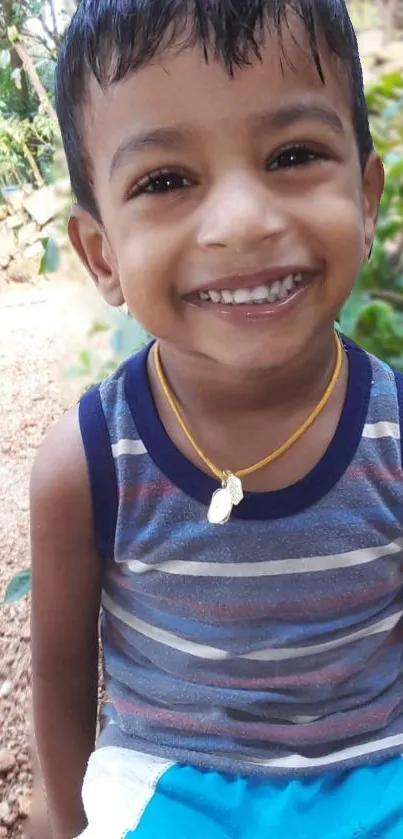 Mobile wallpaper of a smiling child in a striped shirt.