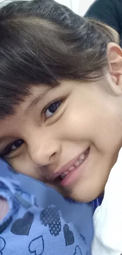 Smiling child portrait with blue and white hues.