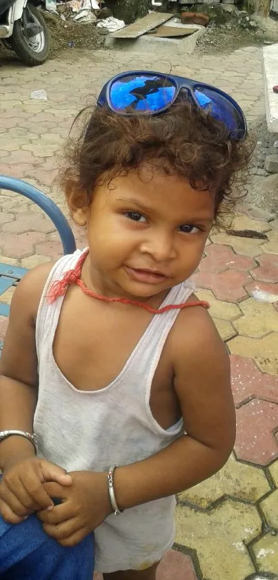 Smiling child in an urban street portrait with vibrant colors.