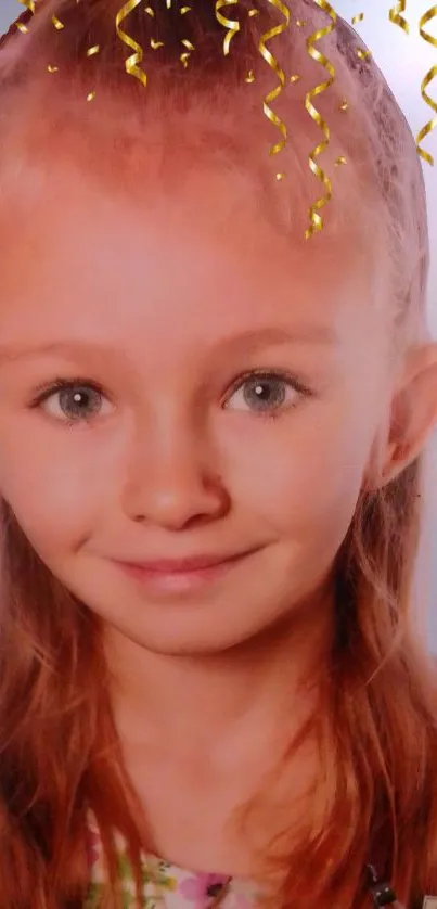 Smiling child with golden curls and light blue background.