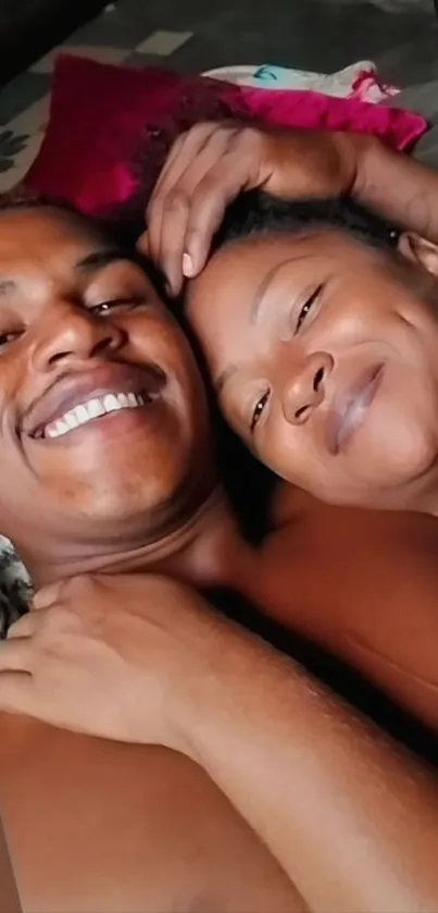 Joyful couple embracing and smiling warmly.